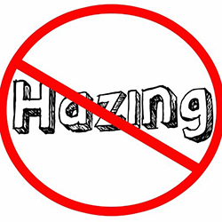The word hazing with a line through it